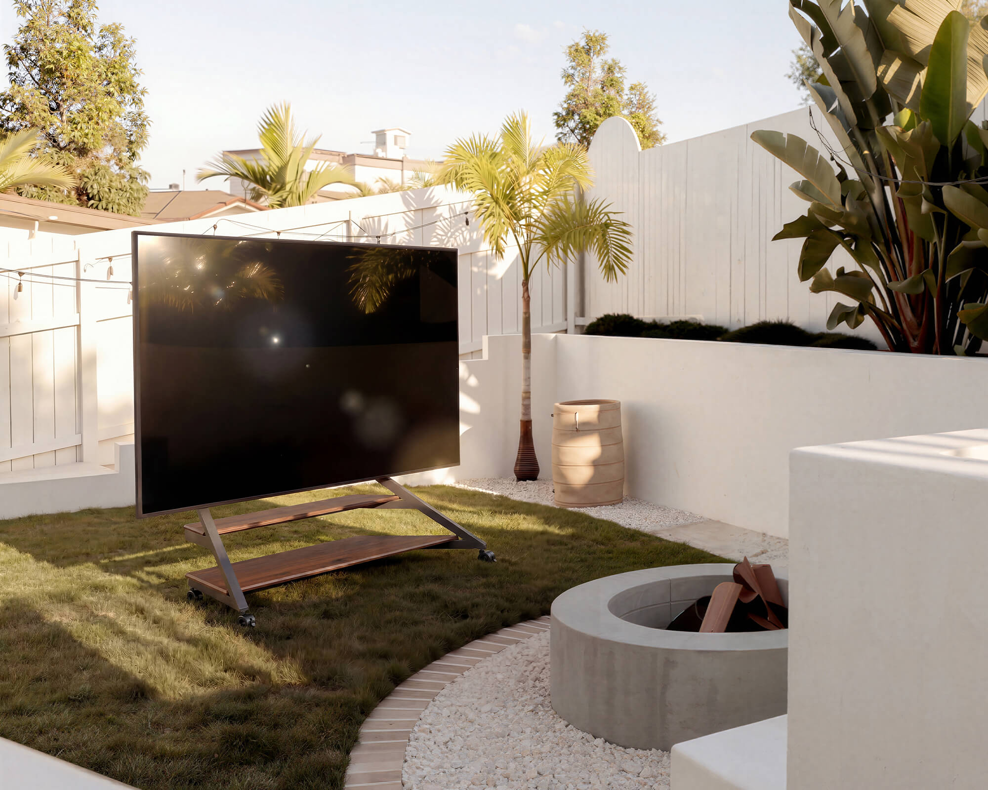Elegant floor tv stand with wheels for flexible outdoor viewing in a garden
