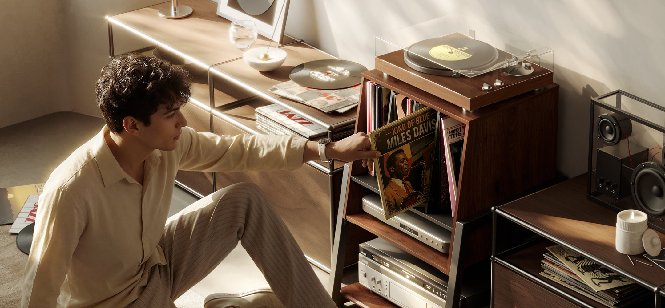 Listener selecting a record from the Eiffel RS05 vinyl storage cabinet