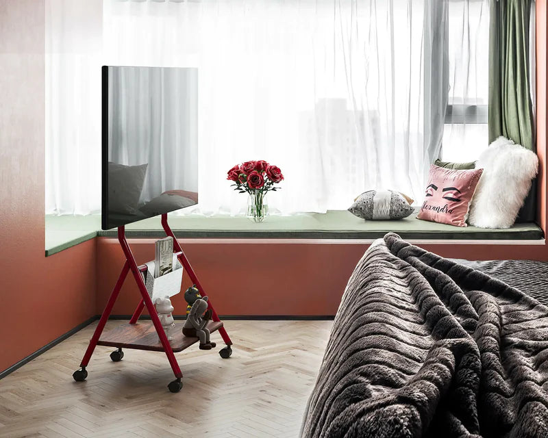 maroon tv stand with wheels in the bedroom