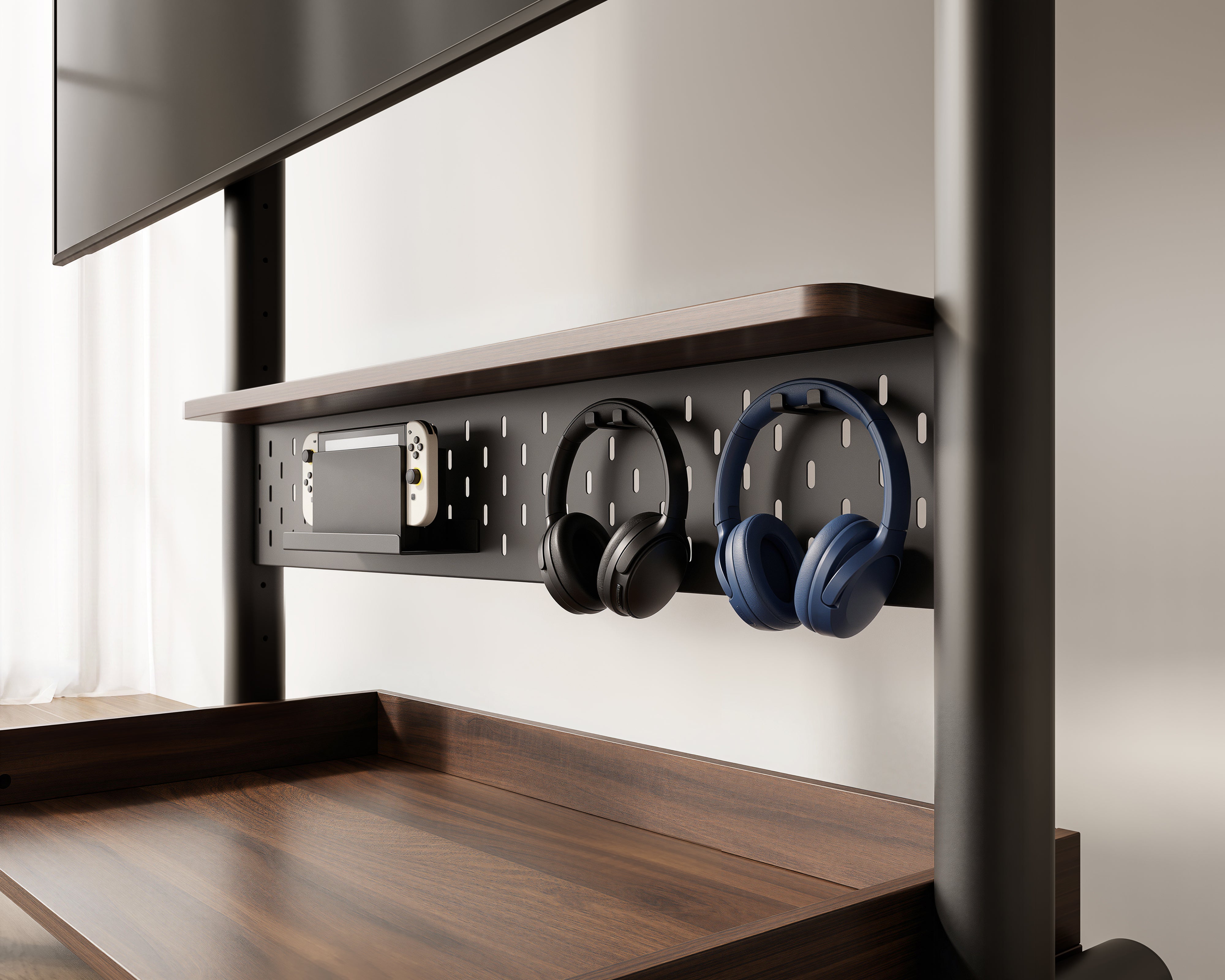 Pegboard accessory panel on the black K TC85 S2 TV trolley with headphones stored neatly